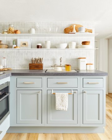 Kitchen with open shelving and mint cabinets