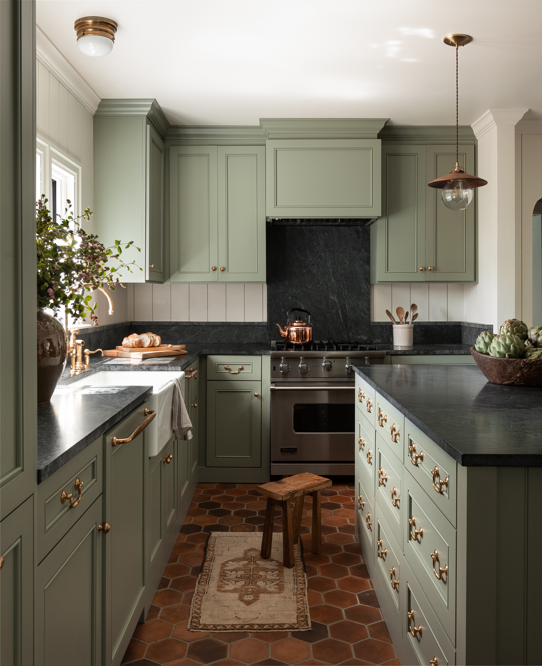 green kitchen with dark black counters