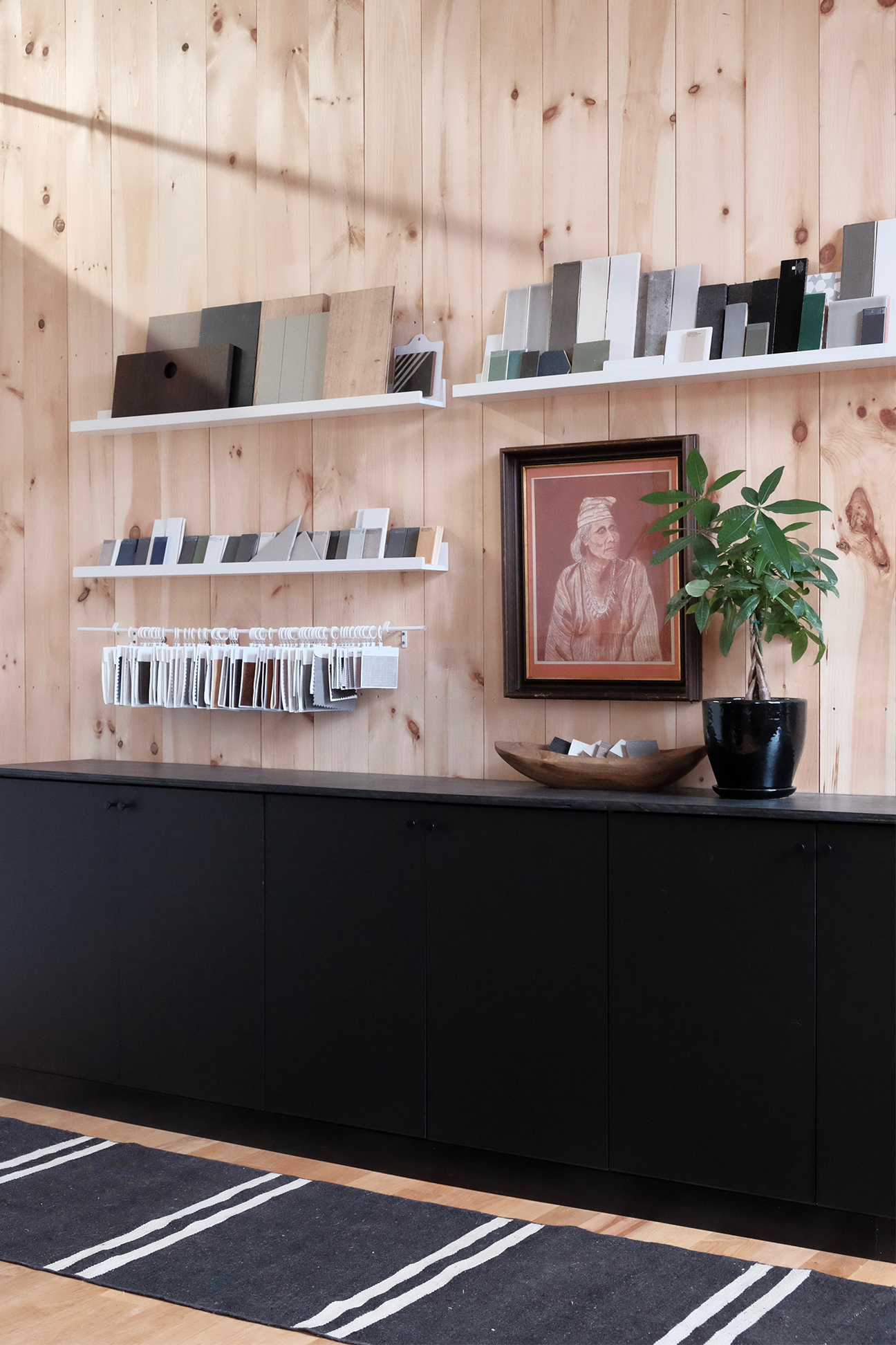 black cabinet with floating shelves above