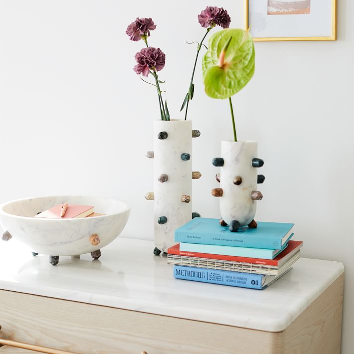 bookshelf with white vessels