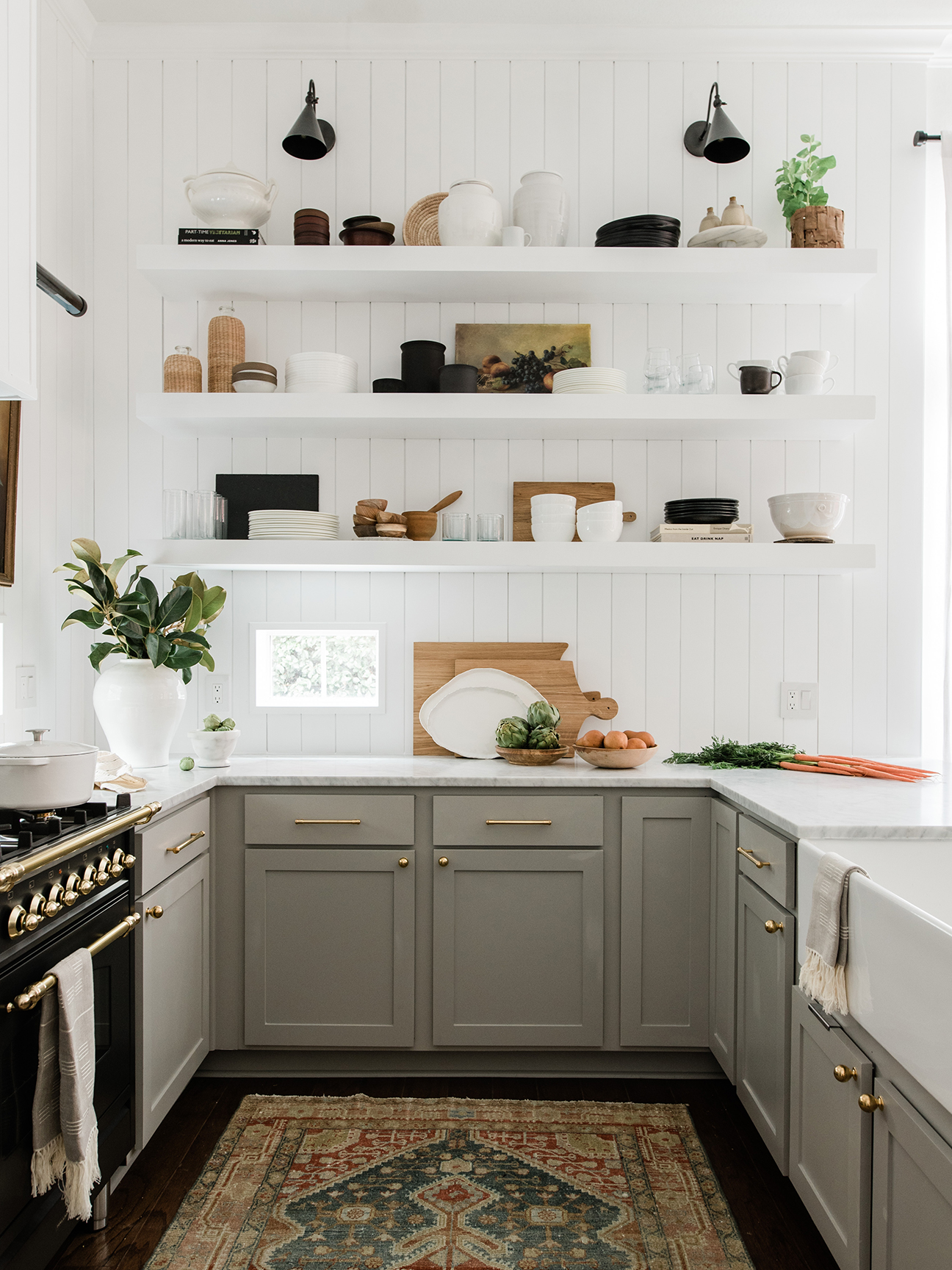 white kitchen with open shelving and gray cabinets