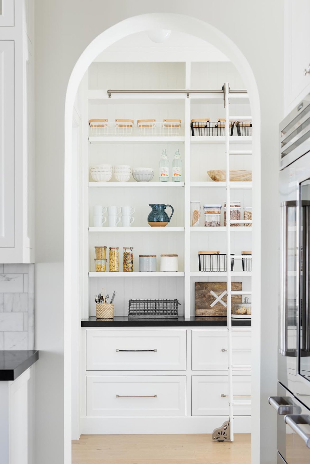 white kitchen pantry with arched ceiling
