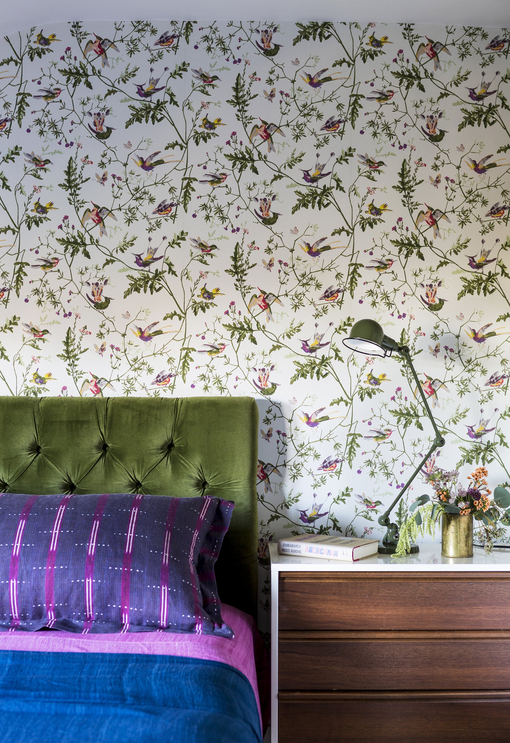 Bedroom with wallpaper and colorful bed