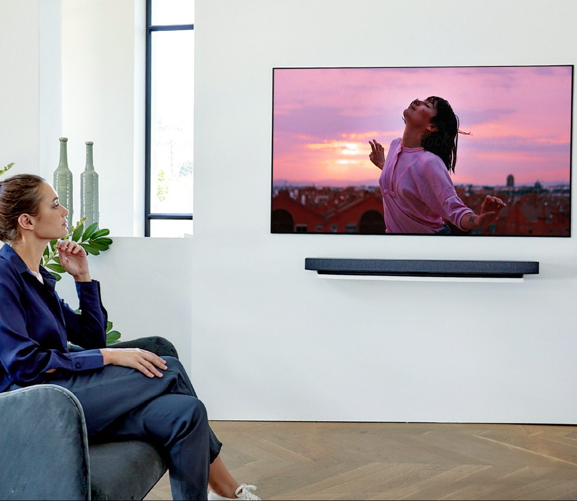 woman sitting in a chair watching tv