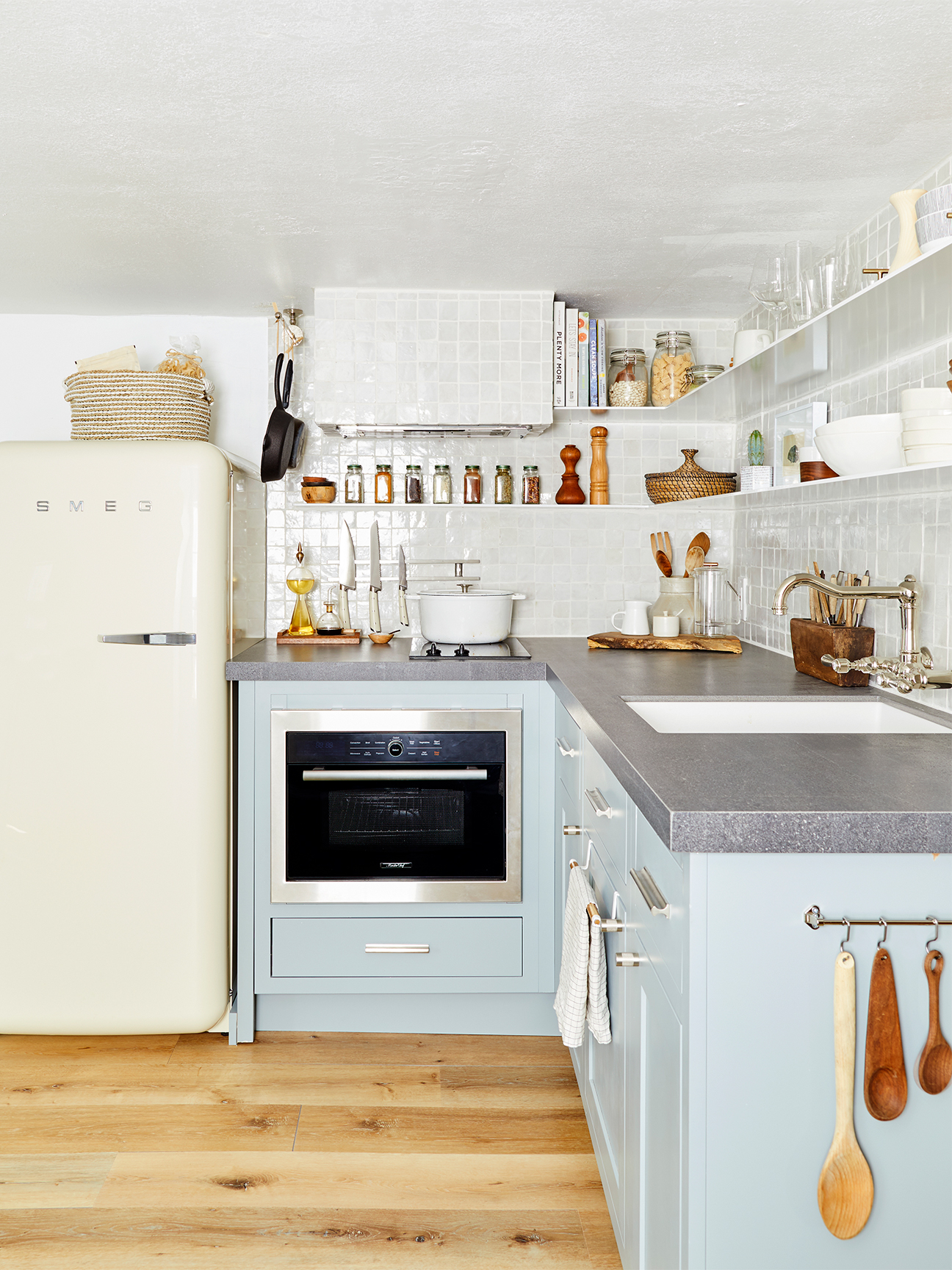 blue kitchen with white smeg fridge