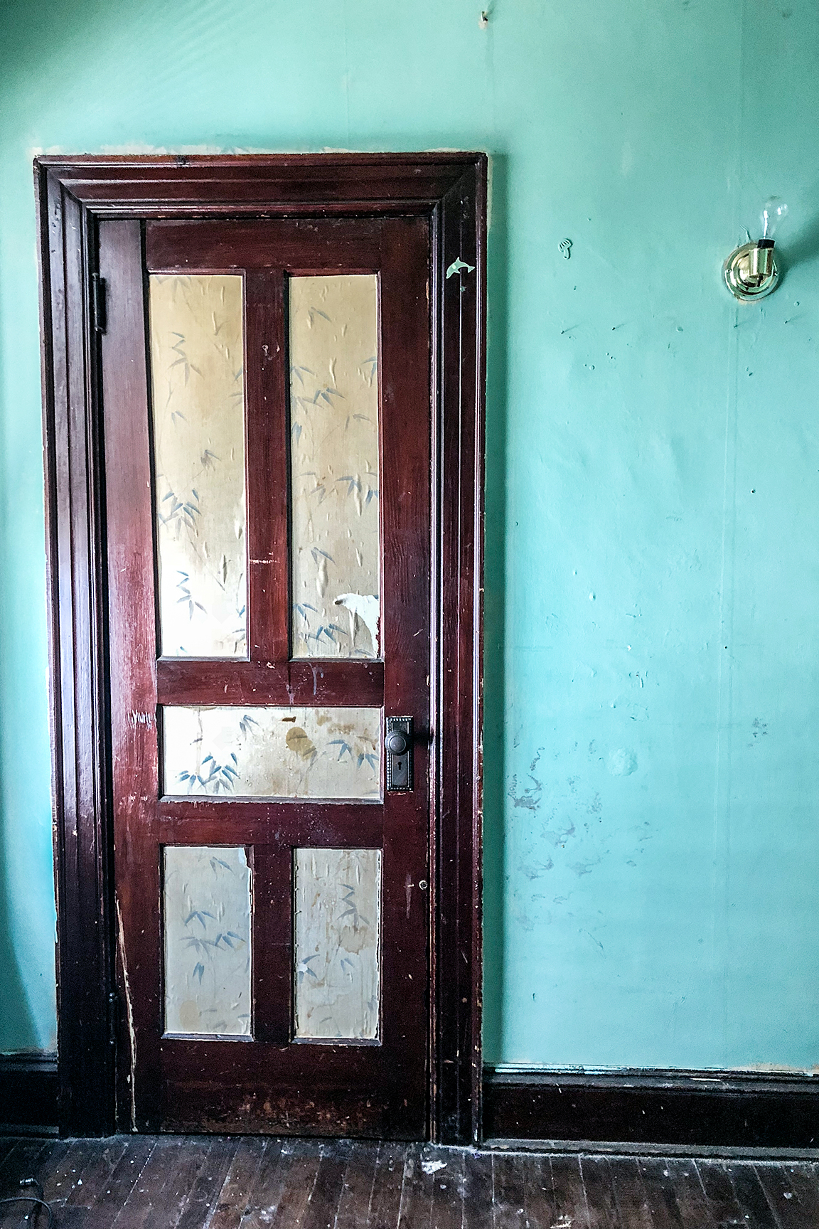 turquoise wall with old door