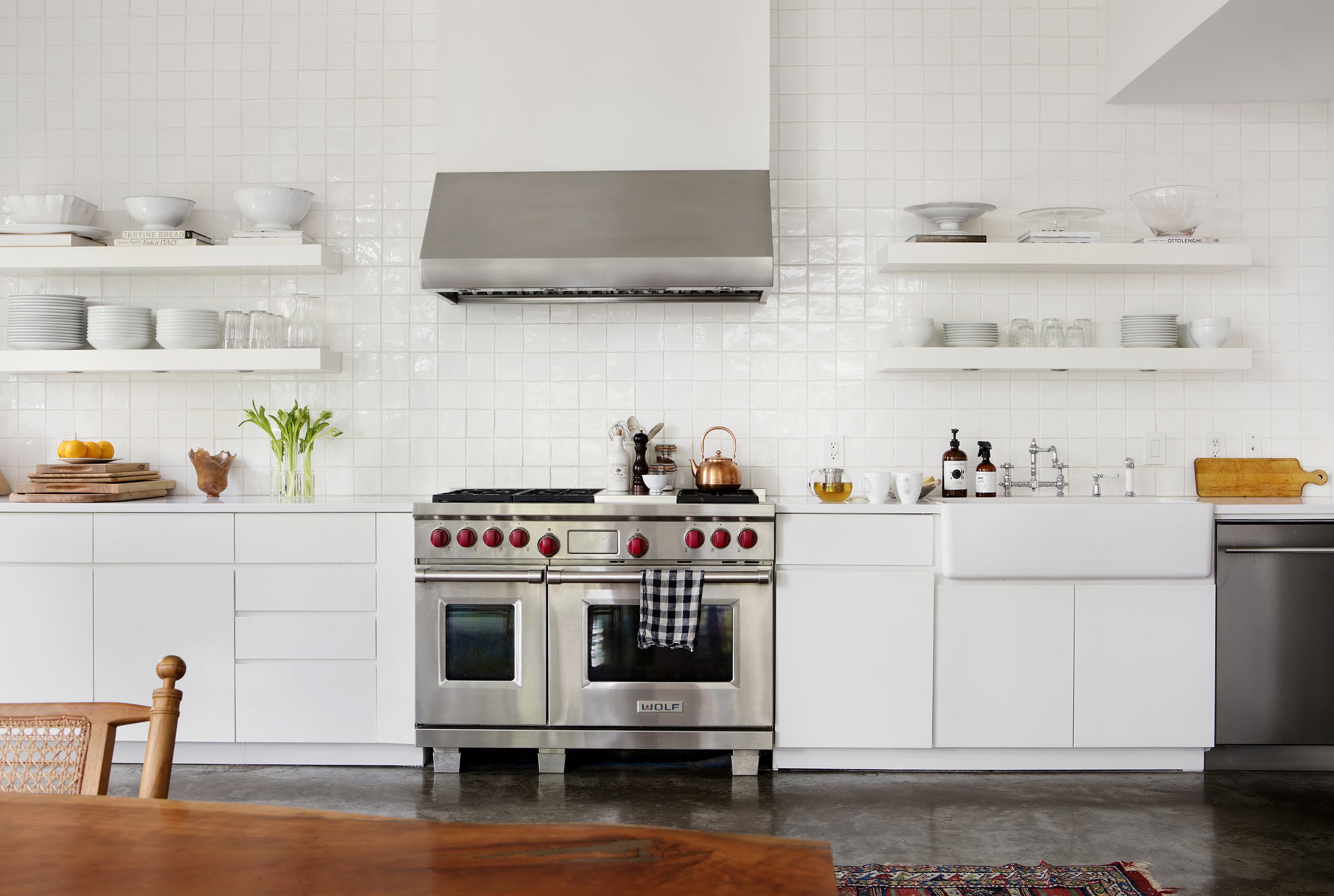 white kitchen with large steel range