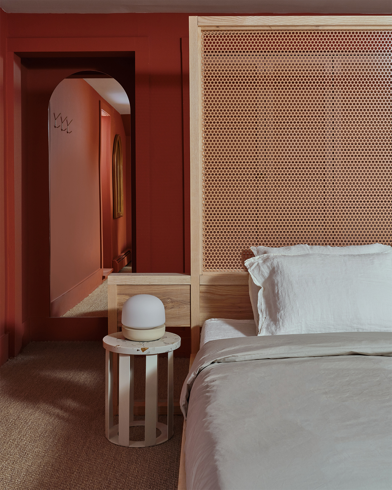 red room with a tall wood headboard