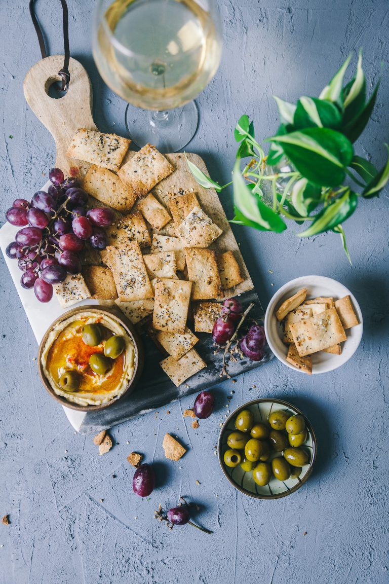 homemade crackers on a board with grapes