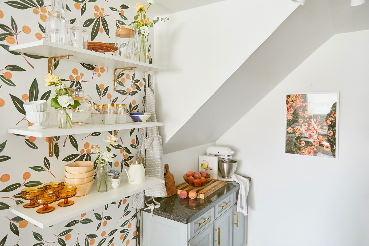 tangerine wallpaper with open shelves and small counter nook