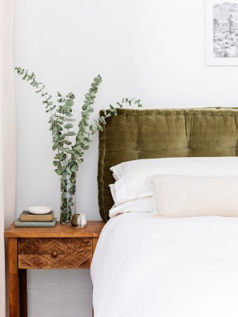 Bedroom with green velvet headboard