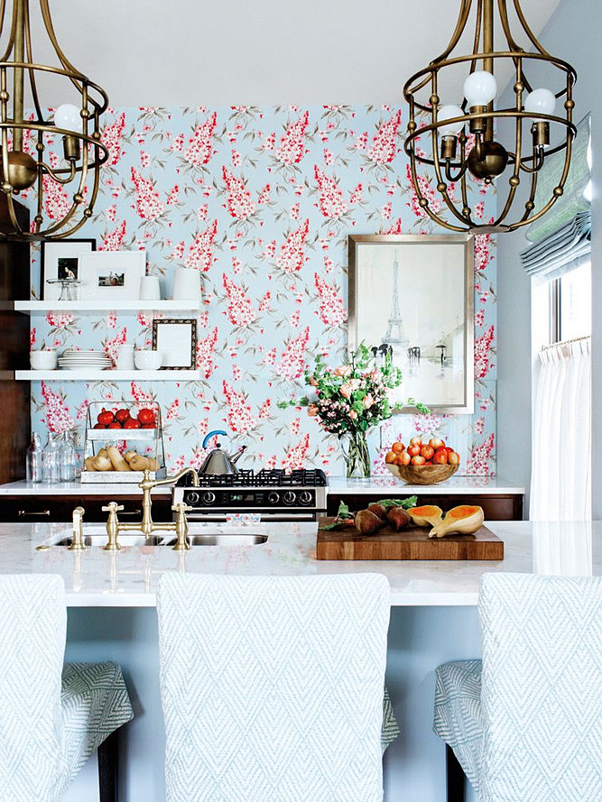 bar stools overlooking kitchen with pink and blue wallpaper wall