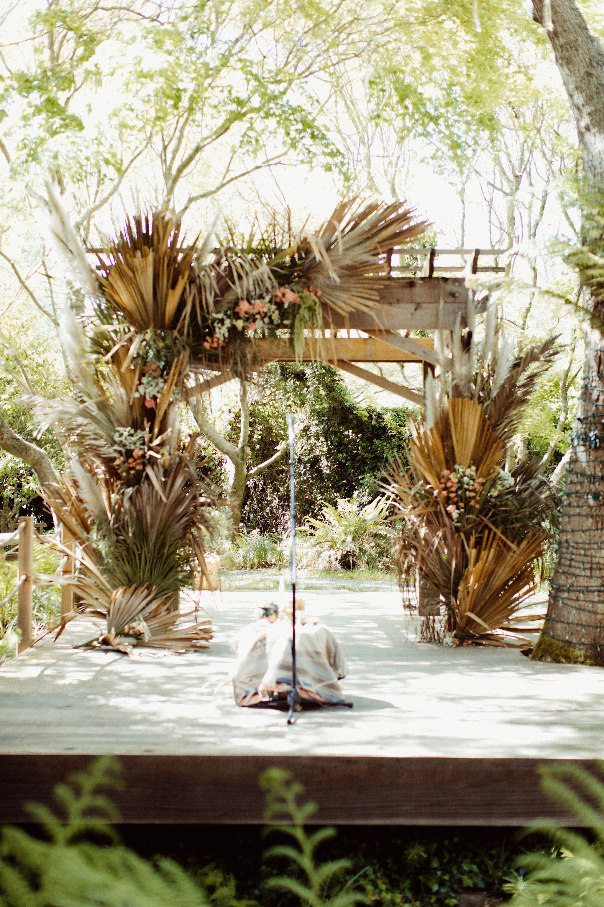 wedding altar covered in palm leaves