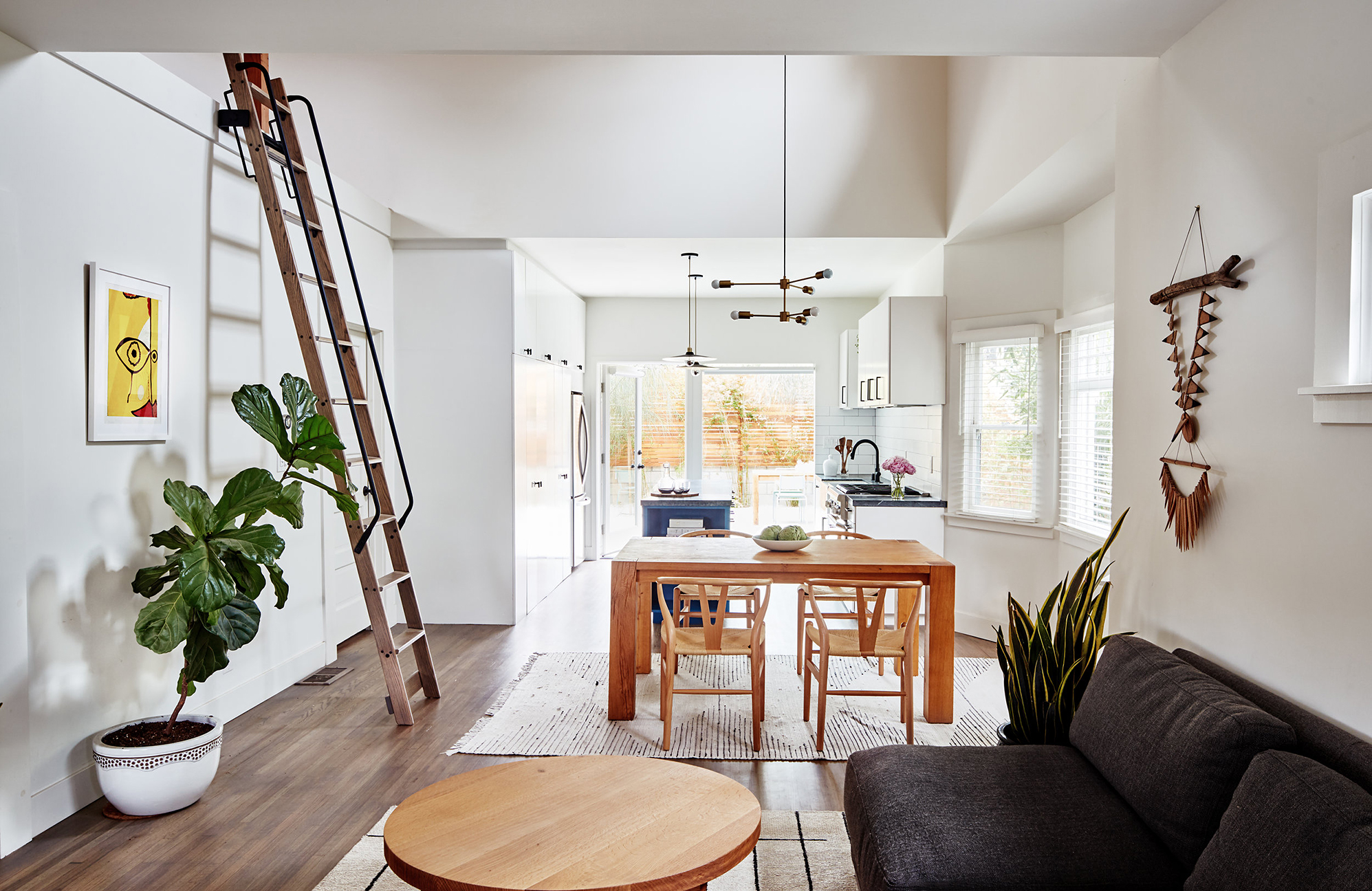 open cnept dining and kitchen and living with ladder on the wall