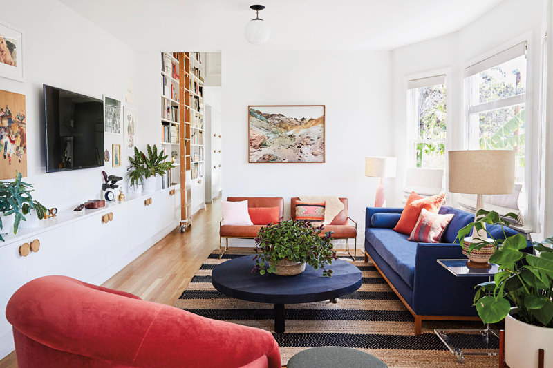 striped living room rug with blue and red sofas