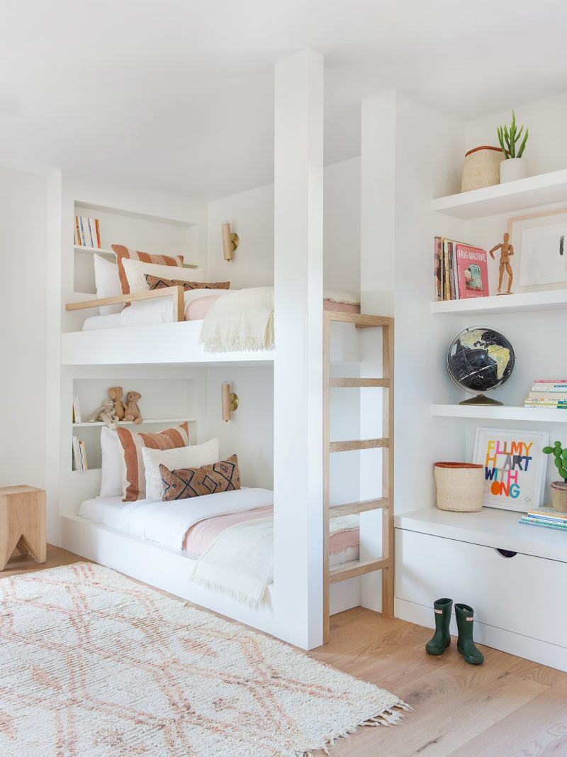 white kids bedroom with bunk beds and pink bedding