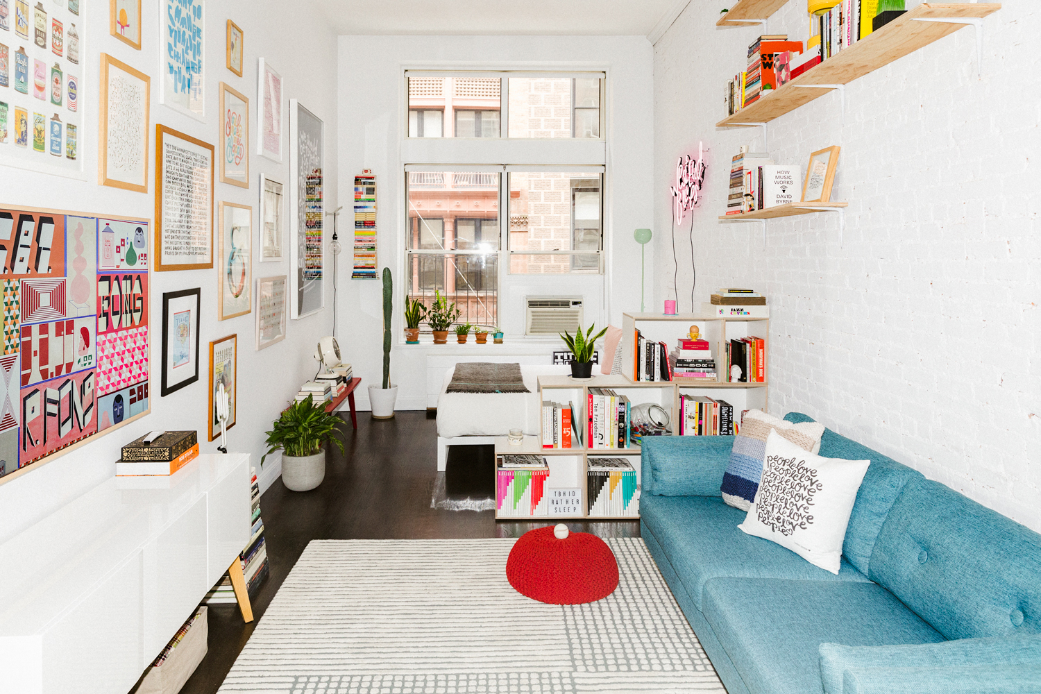 blue sofa in a white room with red table