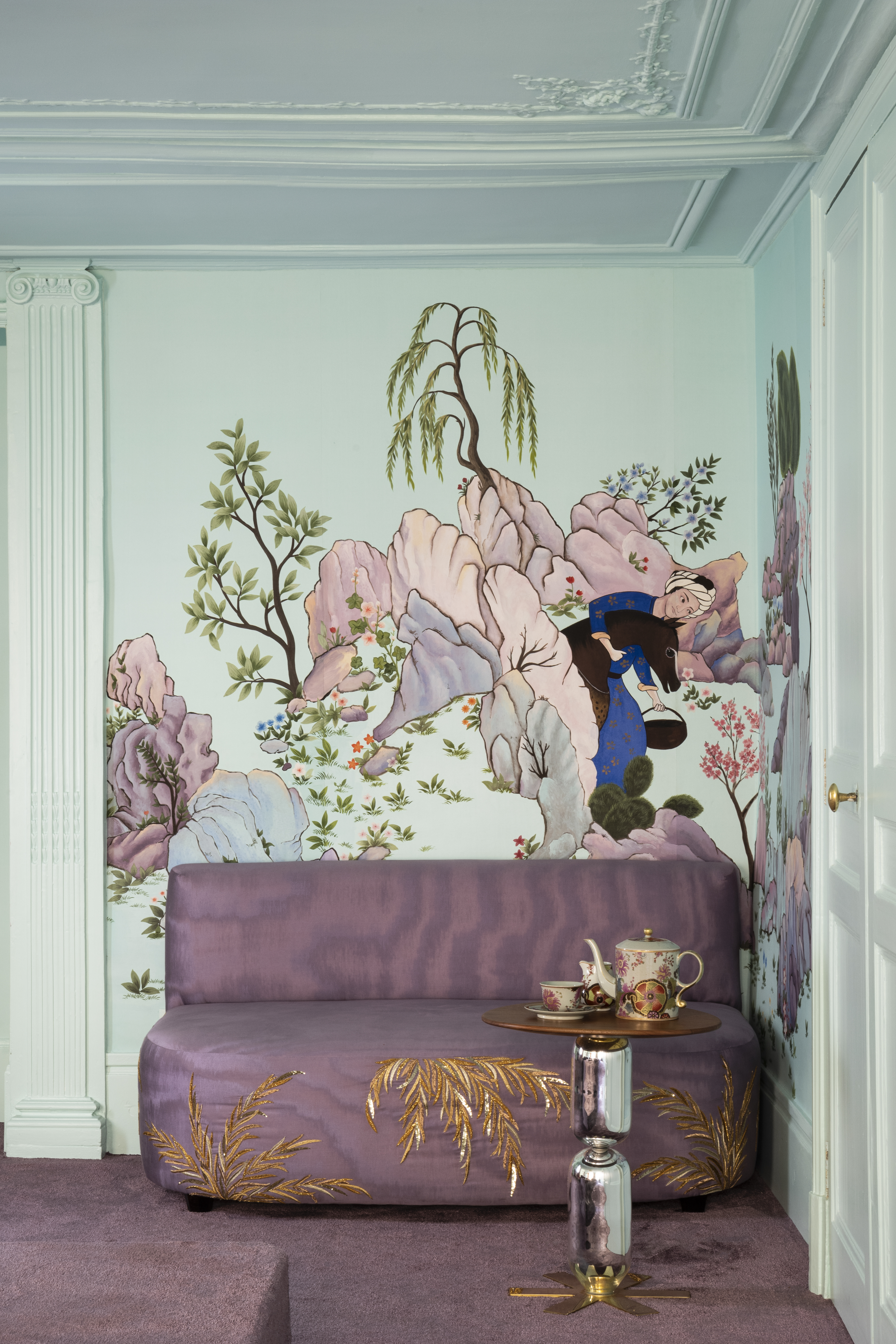 floral wallapper and purple couch