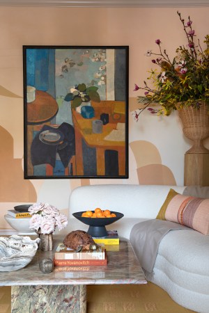 curved whie sofa and large abstract painting on wall