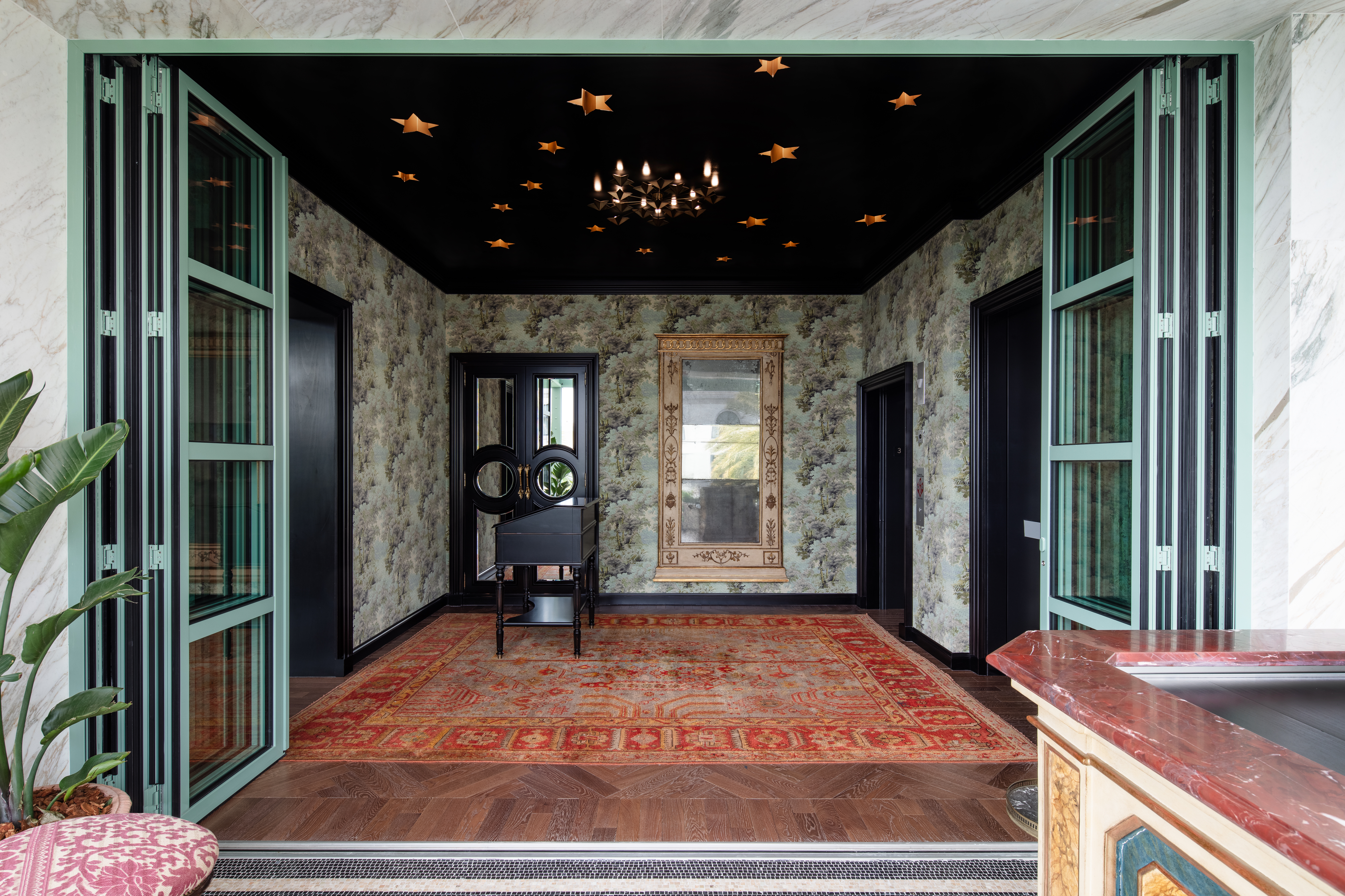 black ceiling entryway with red antique rug