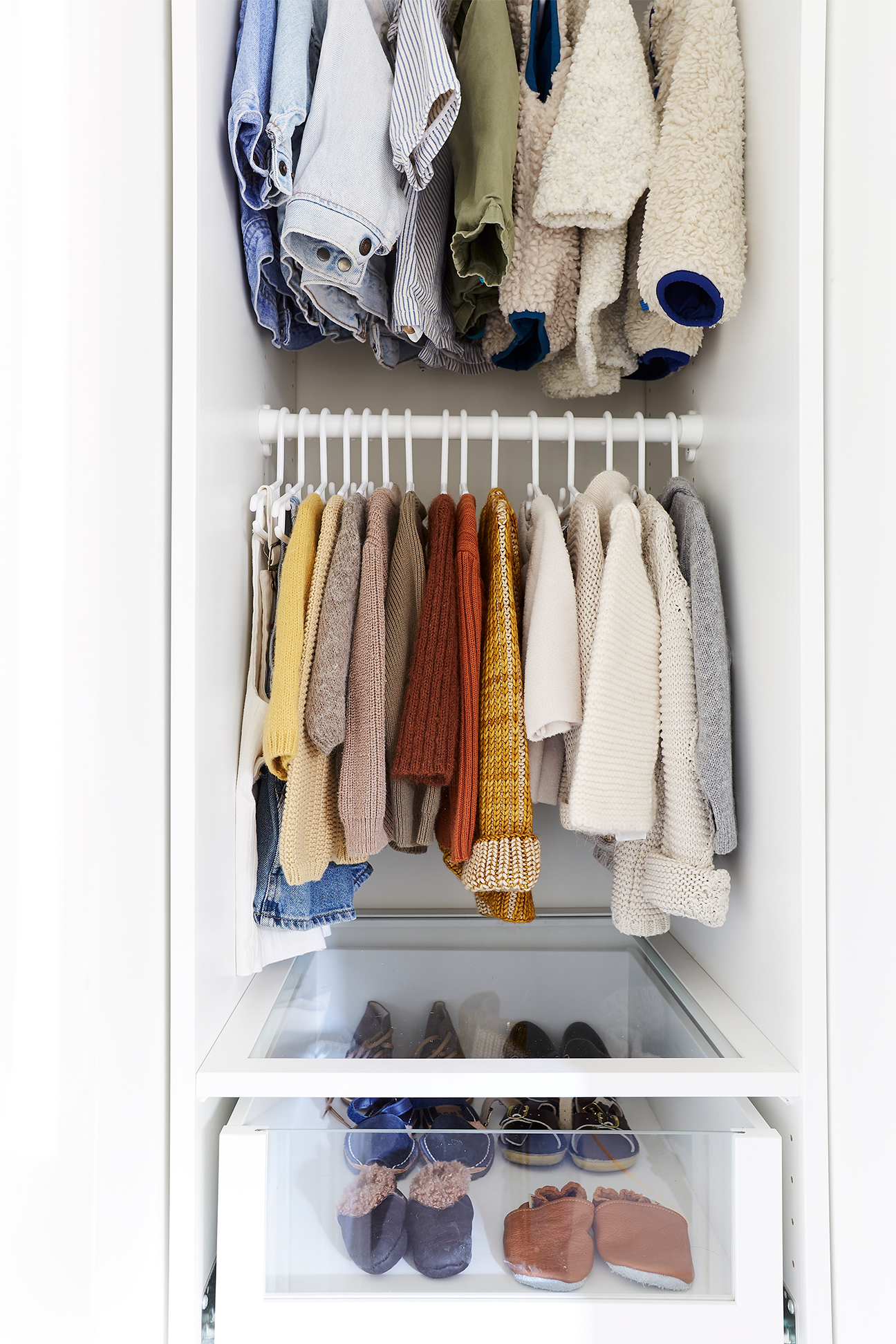 baby sweaters in a closet