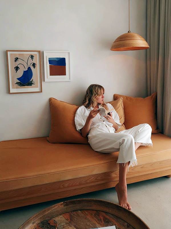 woman sitting on orange sofa