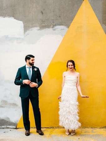 woman and man under a yellow mural