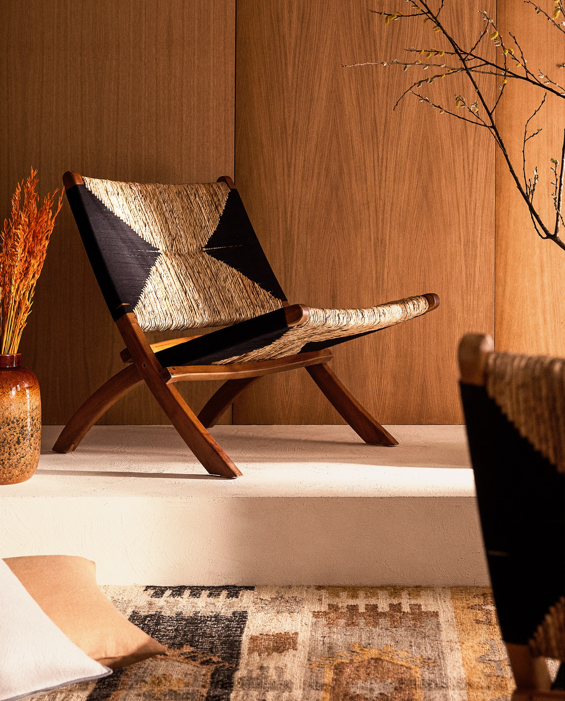 folding woven chair in a wood panel room