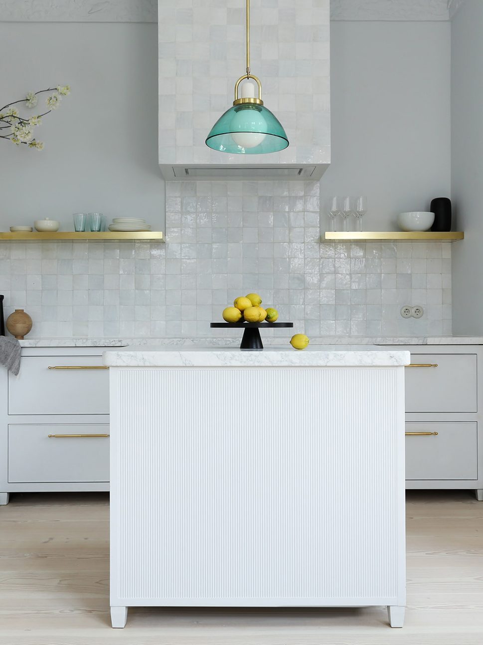 white kitchen with blue pendant over the island