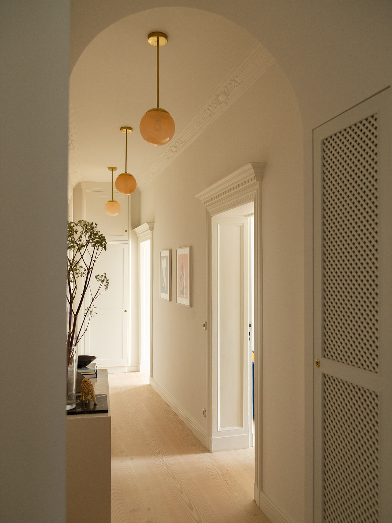 hallway with pink globe pendants