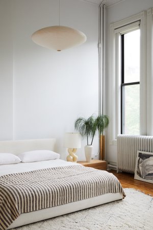 neutral bedroom with paper chandelier