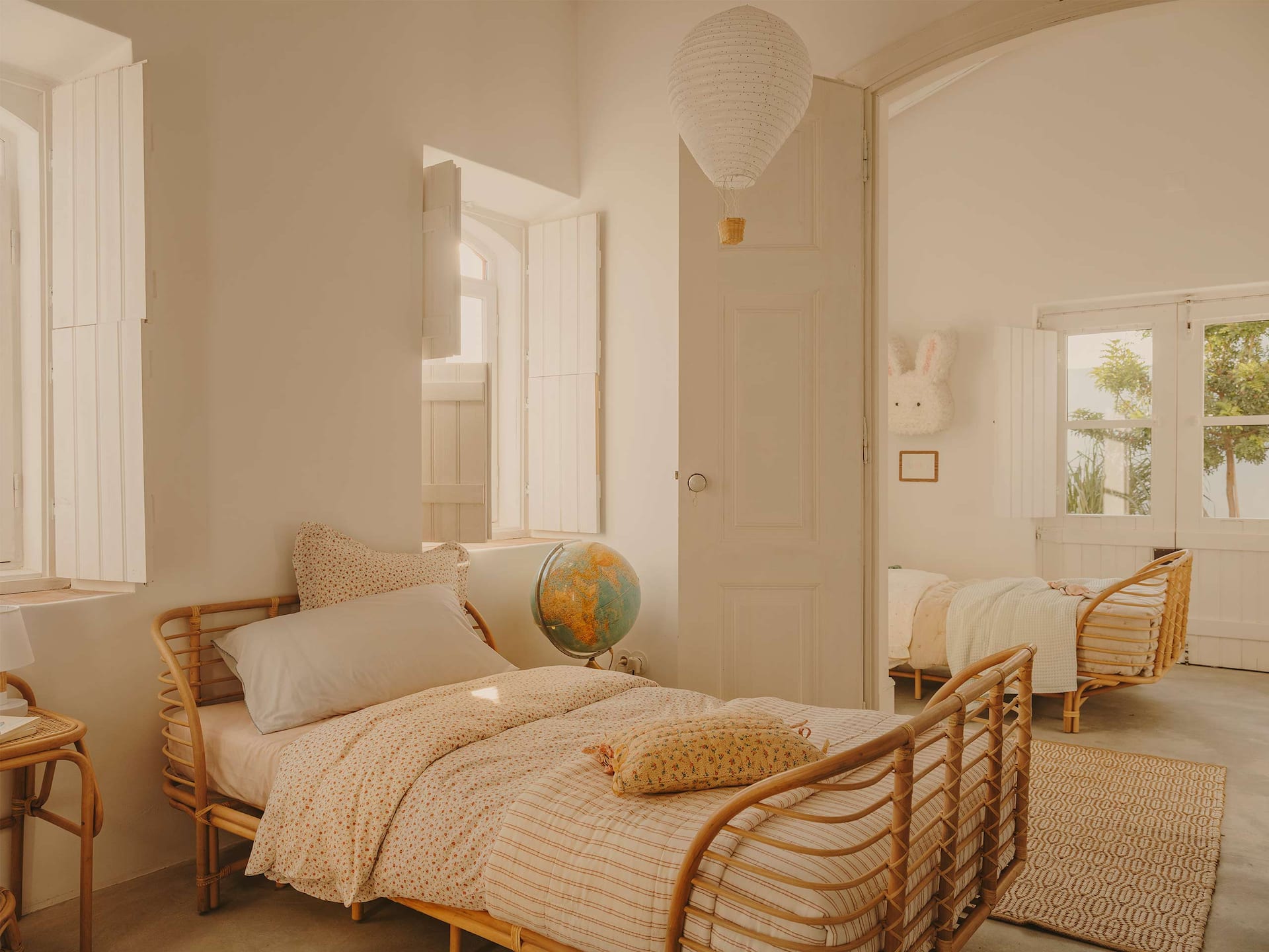 kids room in earthy colors and rattan bed