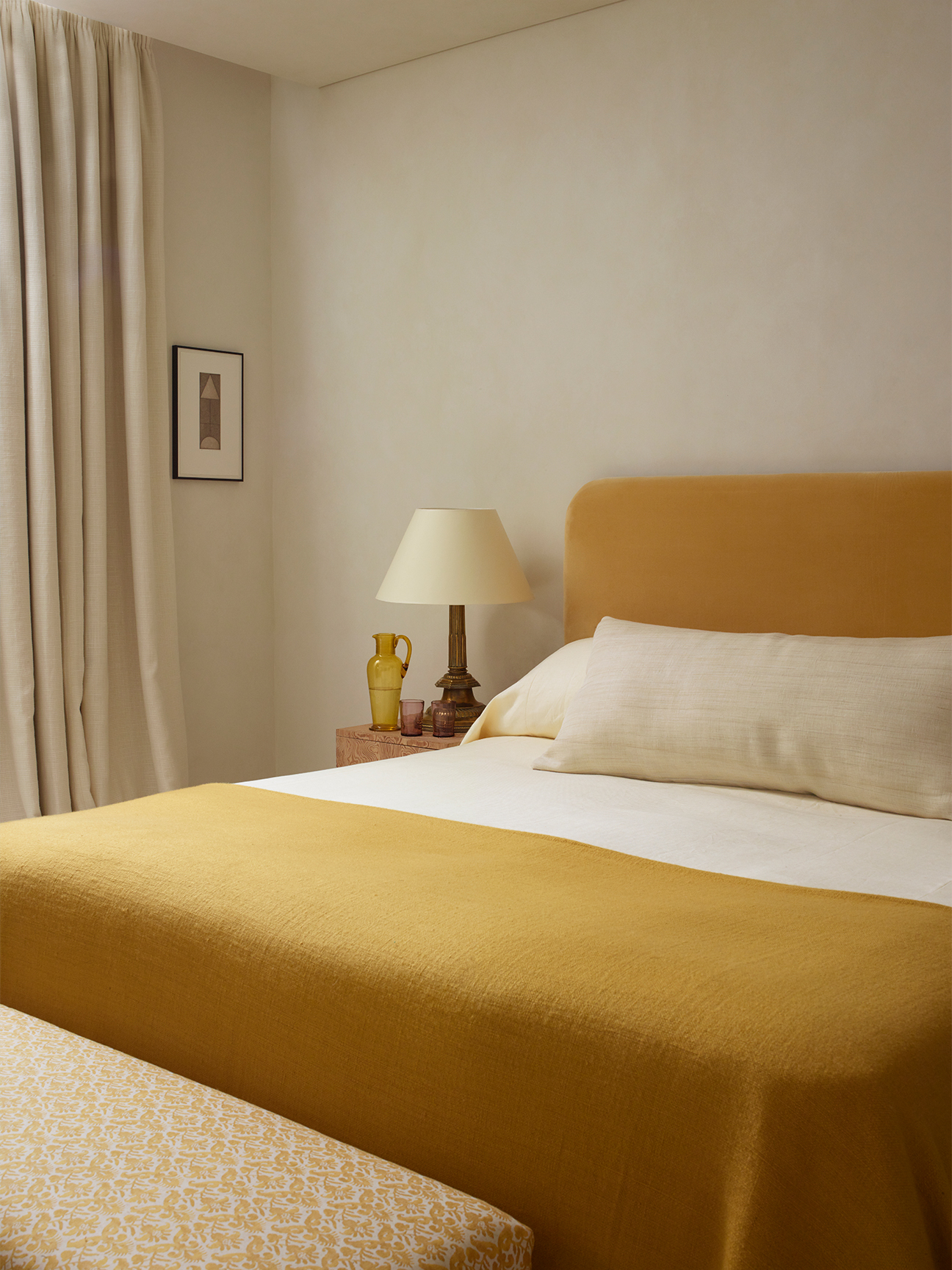 Minimalist bed with matching yellow headboard and quilt