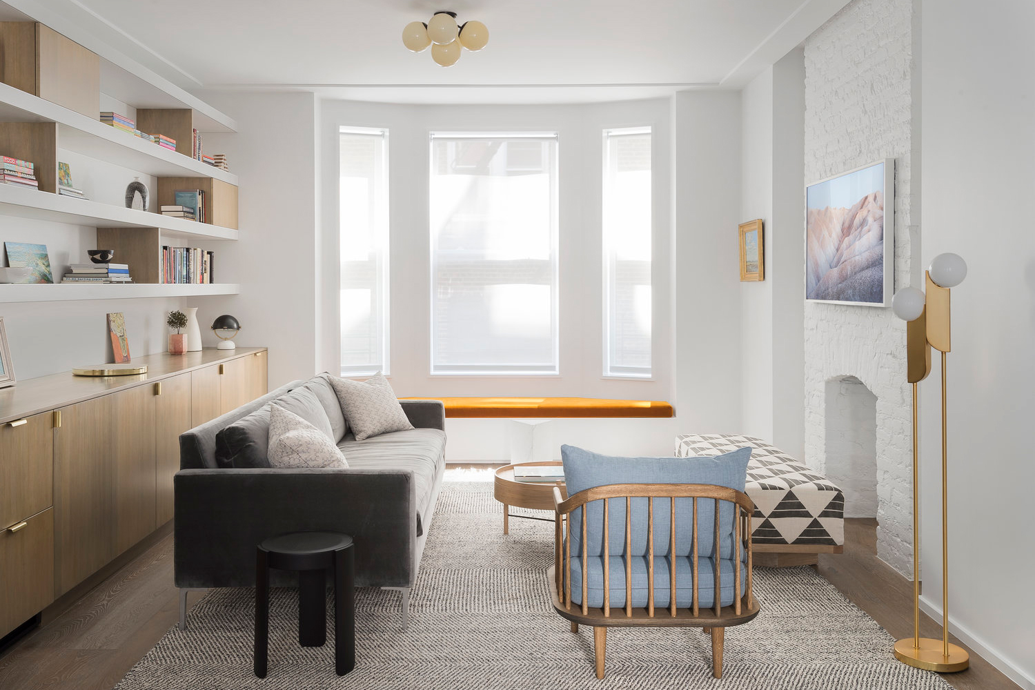 living room with orange window cushions