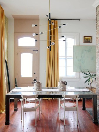 entry with dining table and pink door