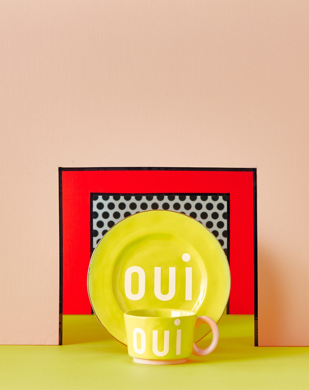 yellow plate in front of pink wall