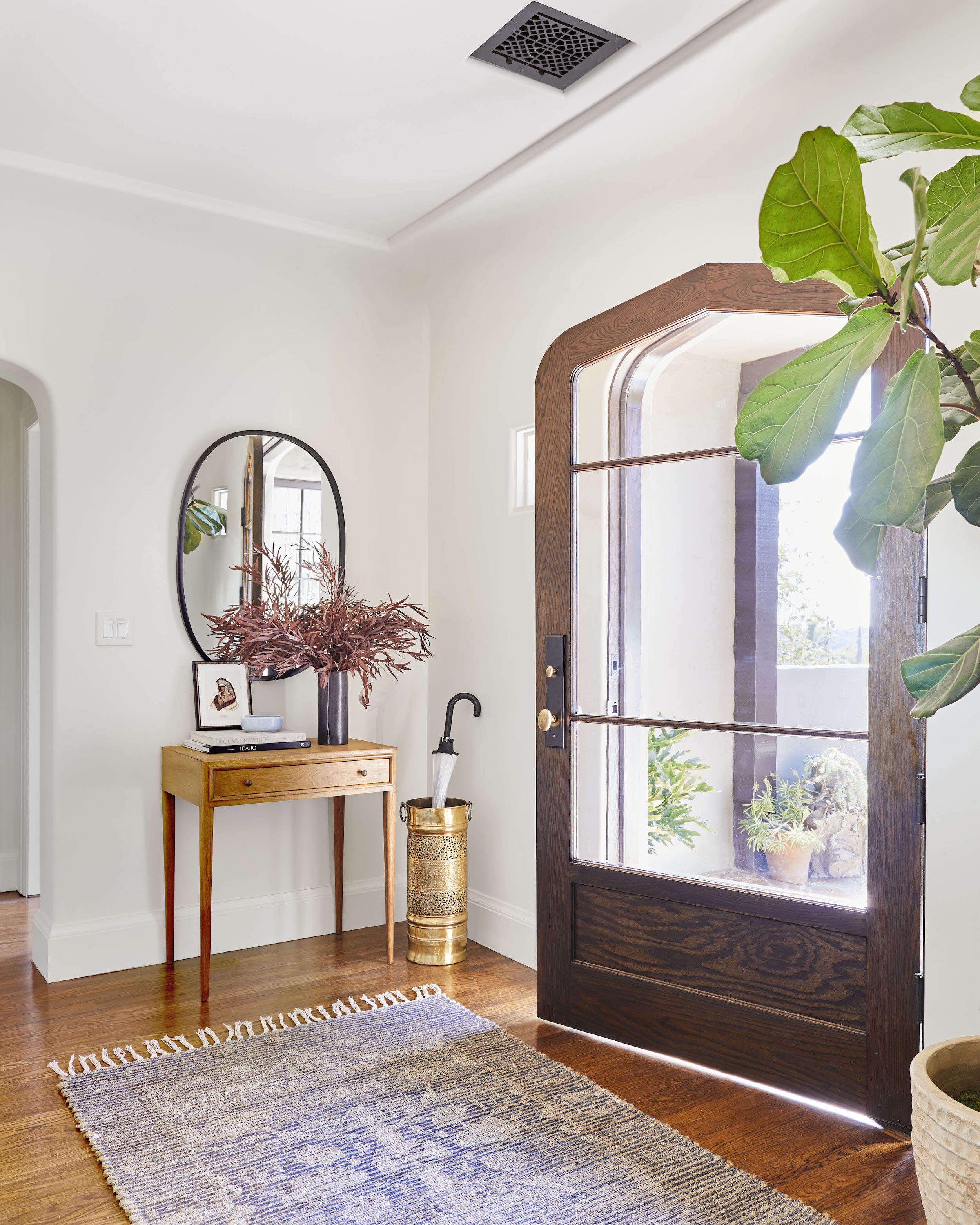 open door with large rug and console table