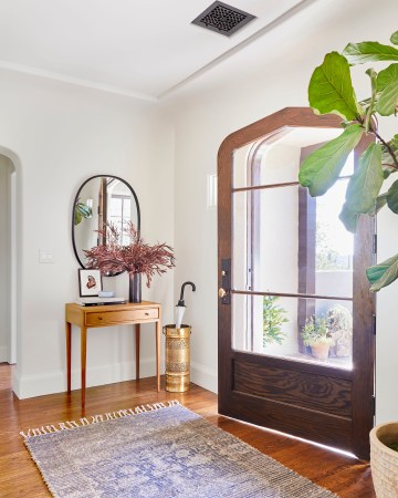 open door with large rug and console table