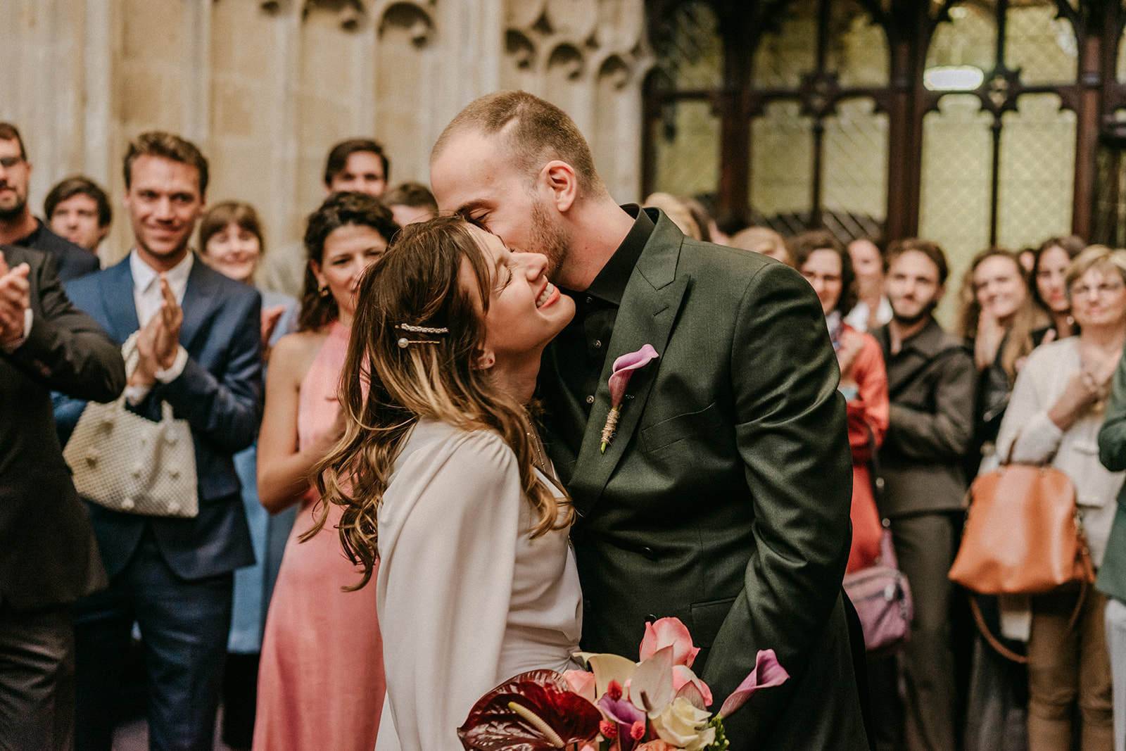 couple kissing outside of chapel