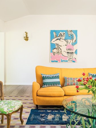 yellow sofa with blue art work