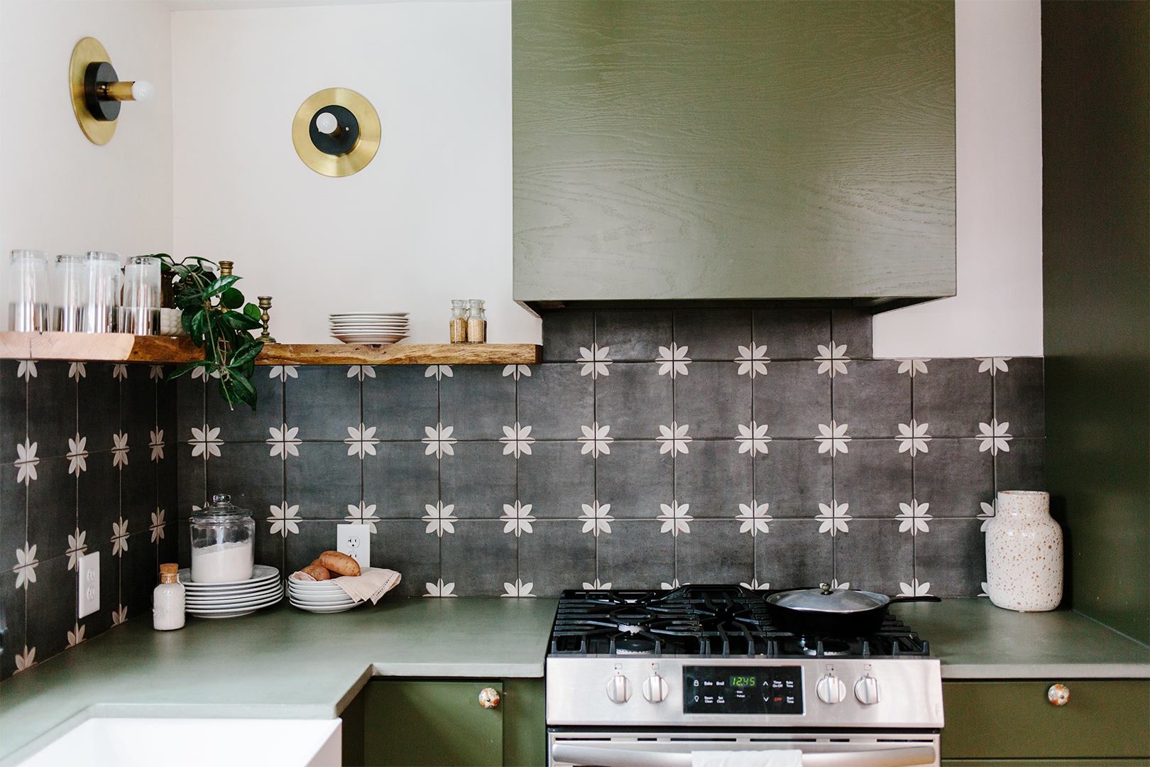 green kitchen with graphic black and white backsplash