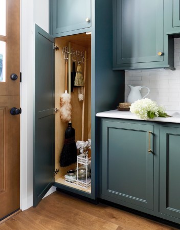 dark green cleaning supplies cabinet