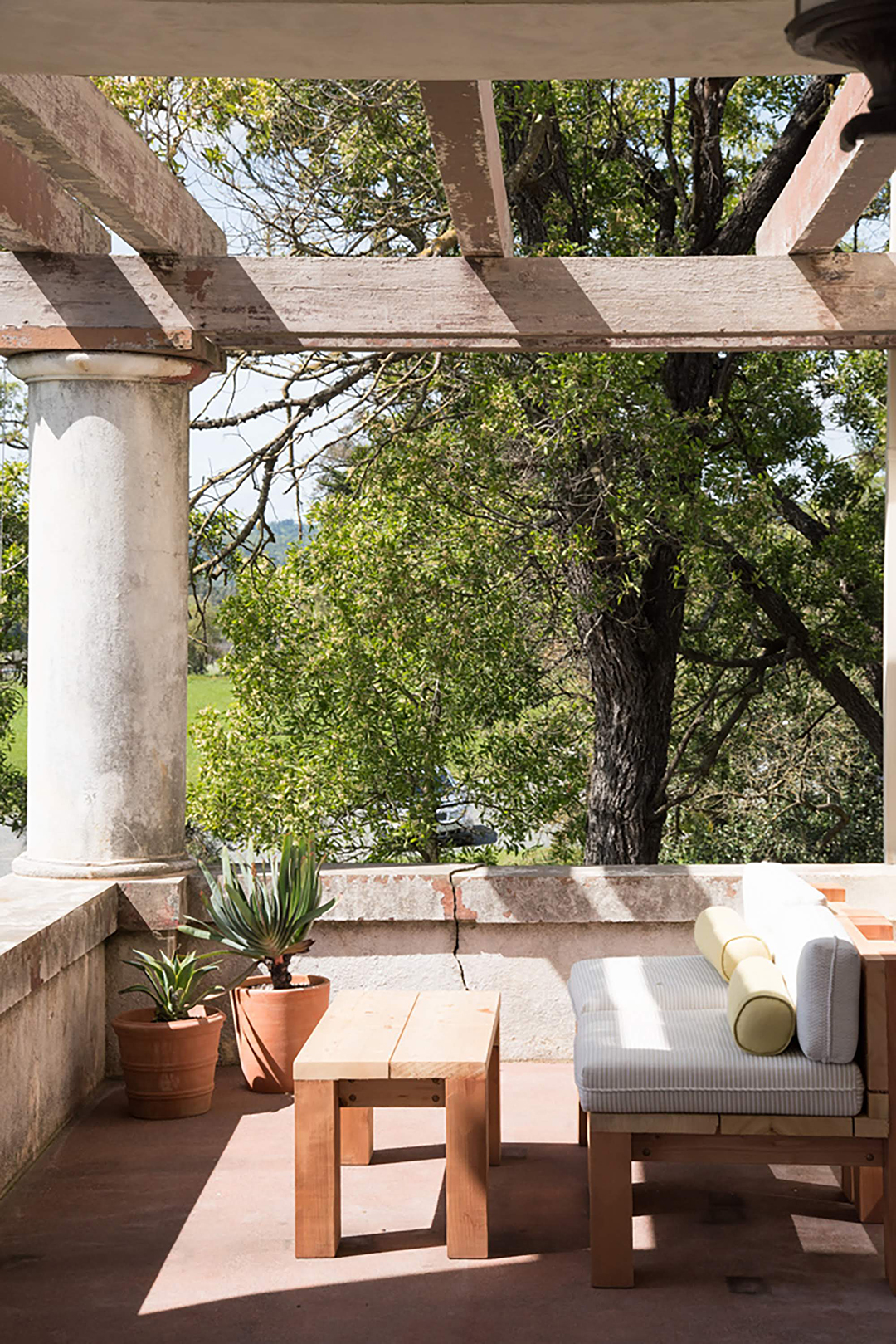 outdoor porch with white sofa and plants