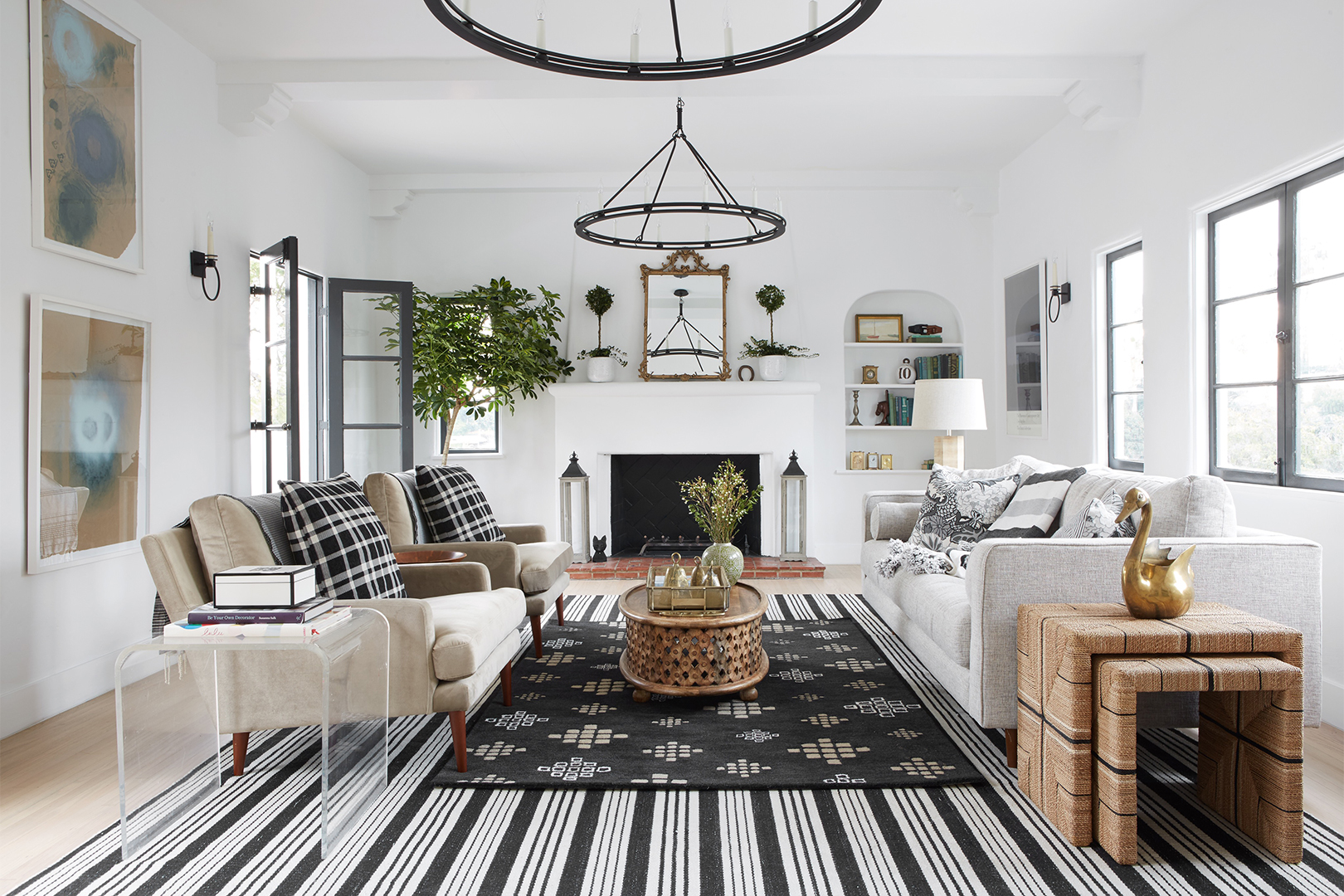 open living room with iron chandeliers and white walls