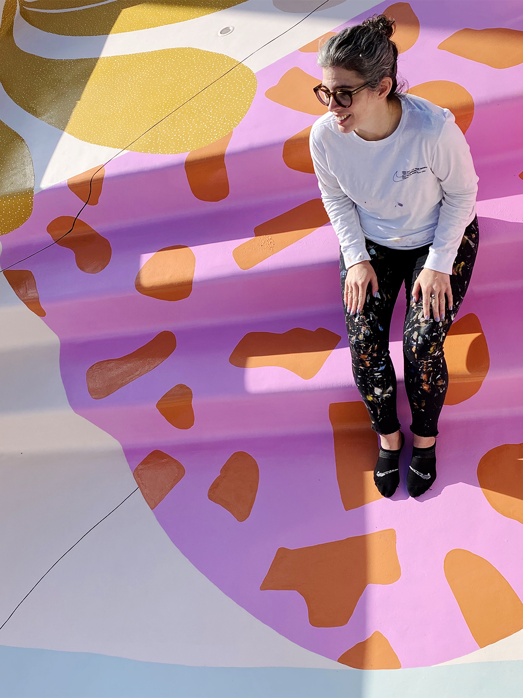 woman in pool with colorful shapes