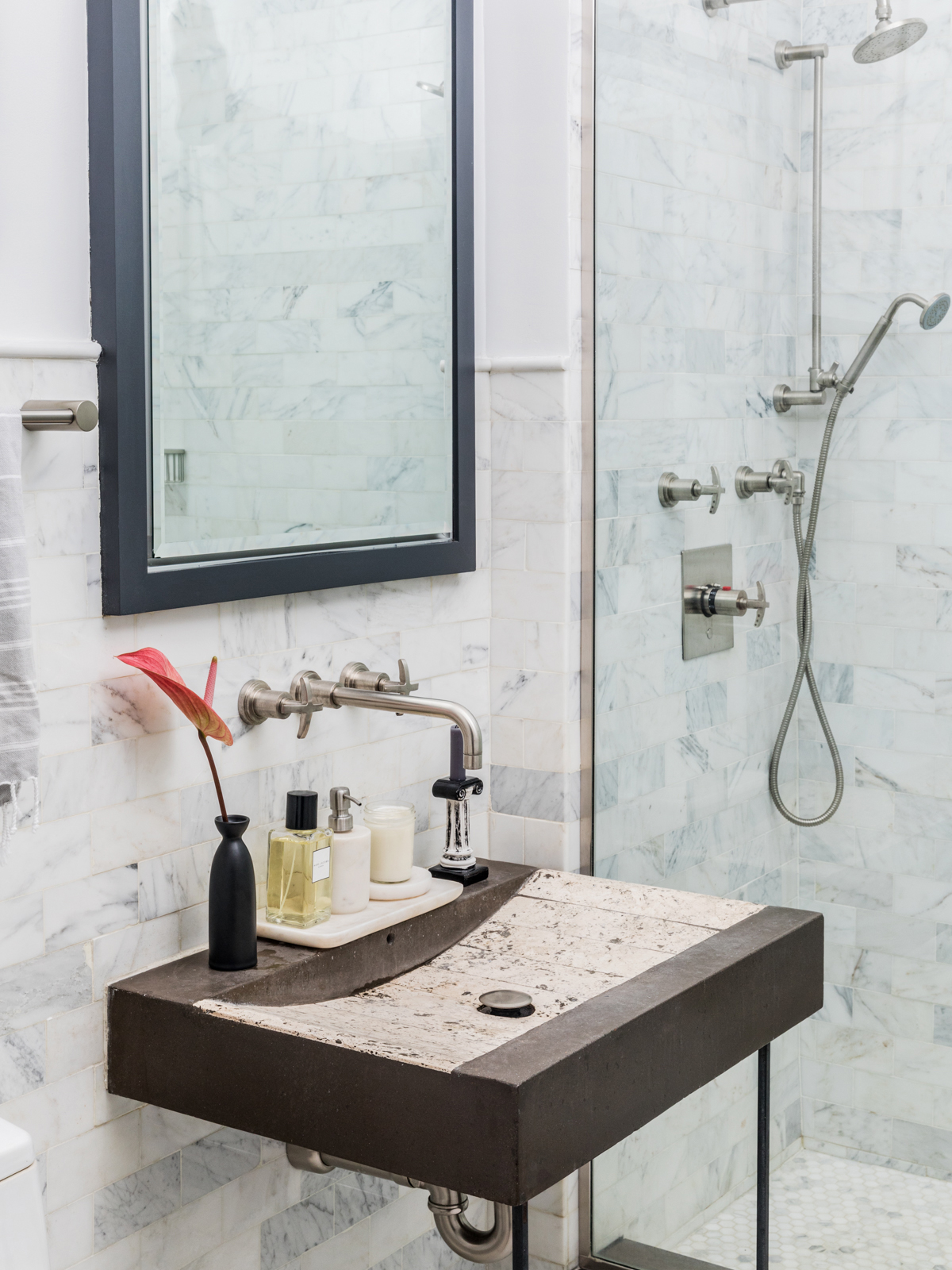 Simple bathroom sink with anthurium in vase