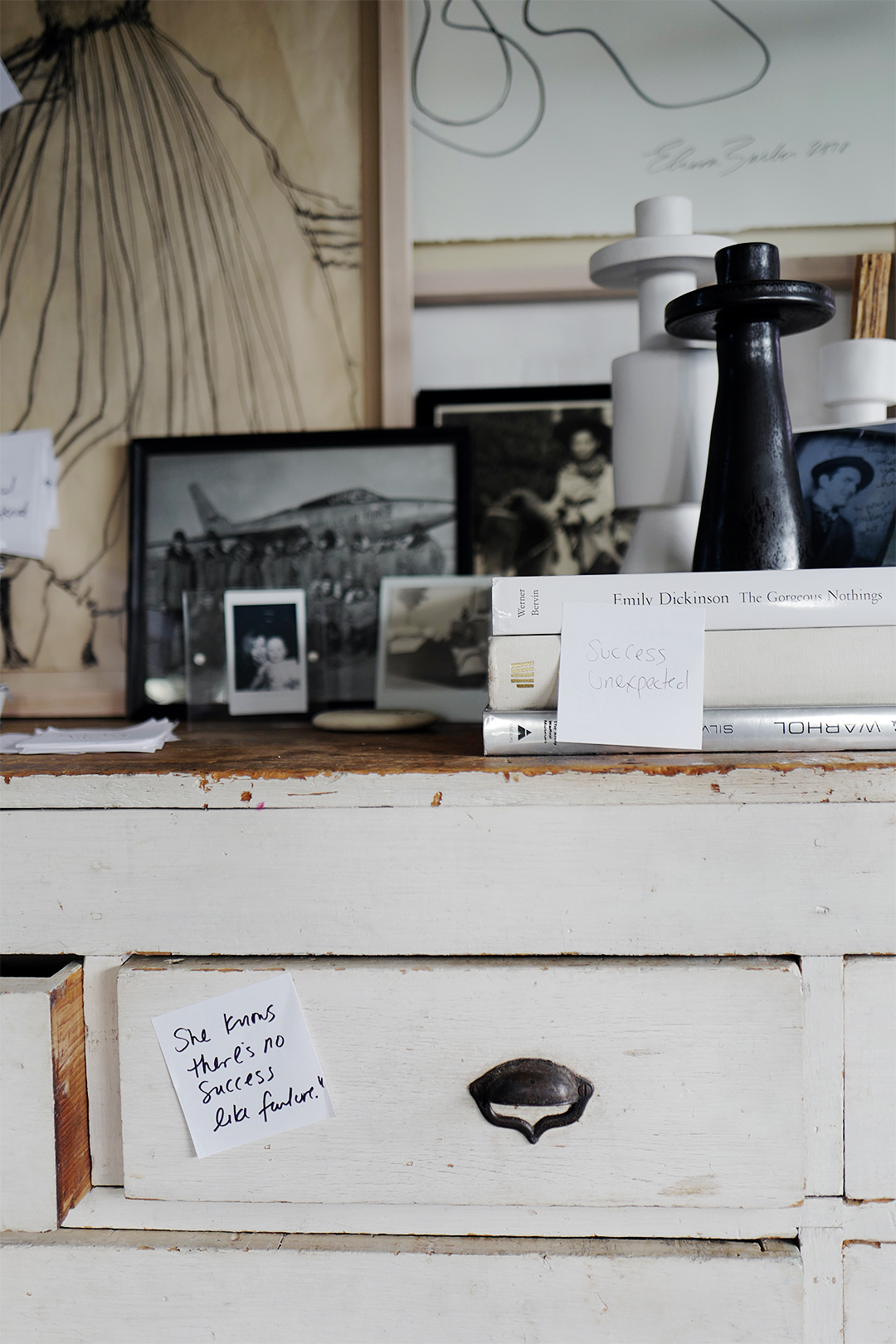 white cabinet with art and sticky notes