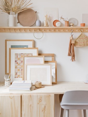 wood frames leaning against wall on top of desk