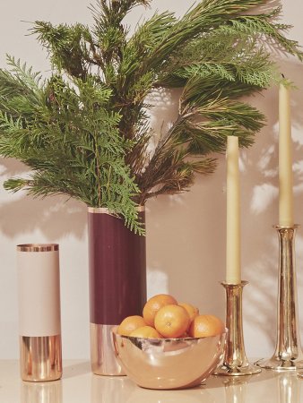 vase bowl of oranges and yellow tapered candles