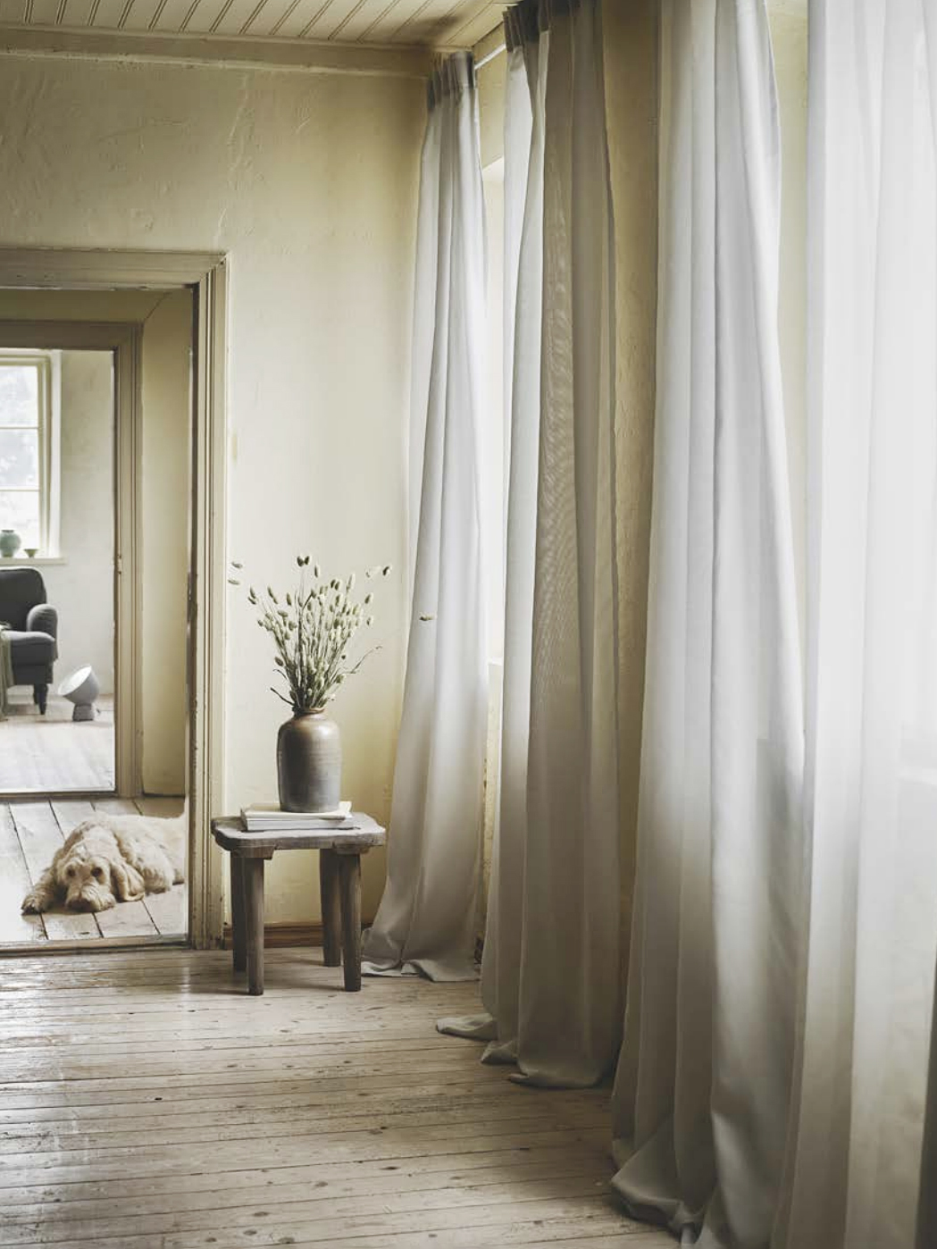 white curtains in a neutral hallway